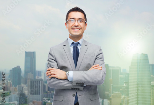 happy smiling businessman in eyeglasses and suit