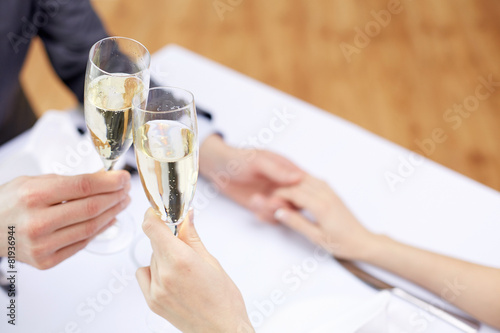 couple with glasses of champagne at restaurant