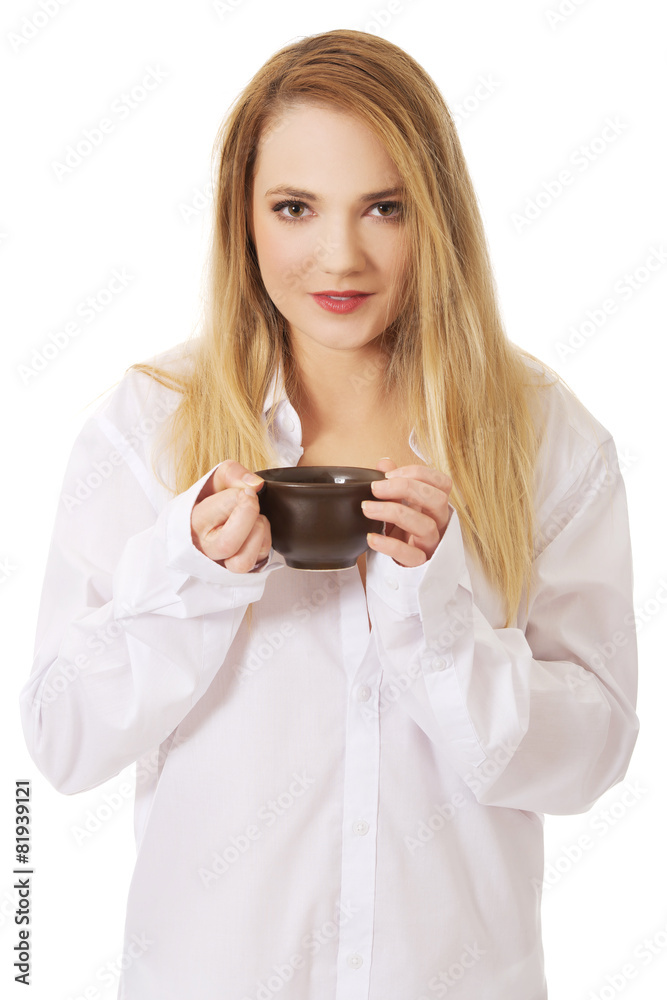 Woman in long sleeve shirt drinking coffee. Woman in long sleeve shirt drinking coffee.
