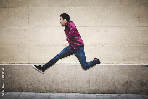 Real man jumping with clear background wall