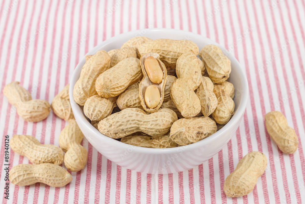 closeup of salted groundnuts in white bowl closeup of salted groundnuts in white bowl