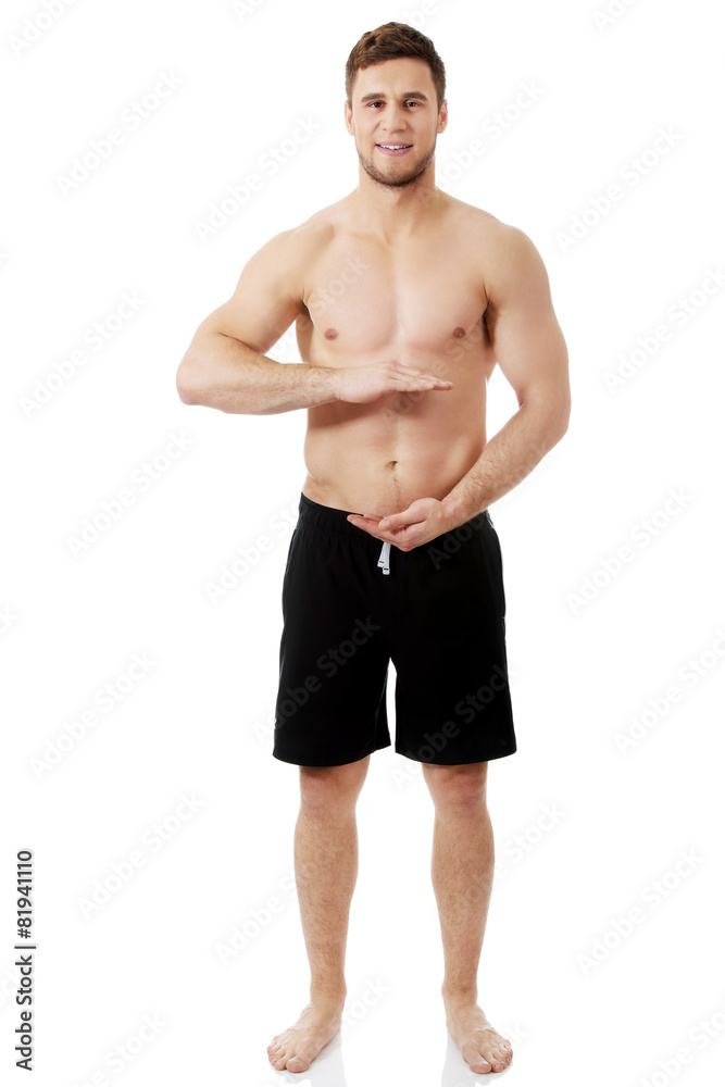 Sexy muscular man holding copyspace in hands. Sexy muscular man holding copyspace in hands.