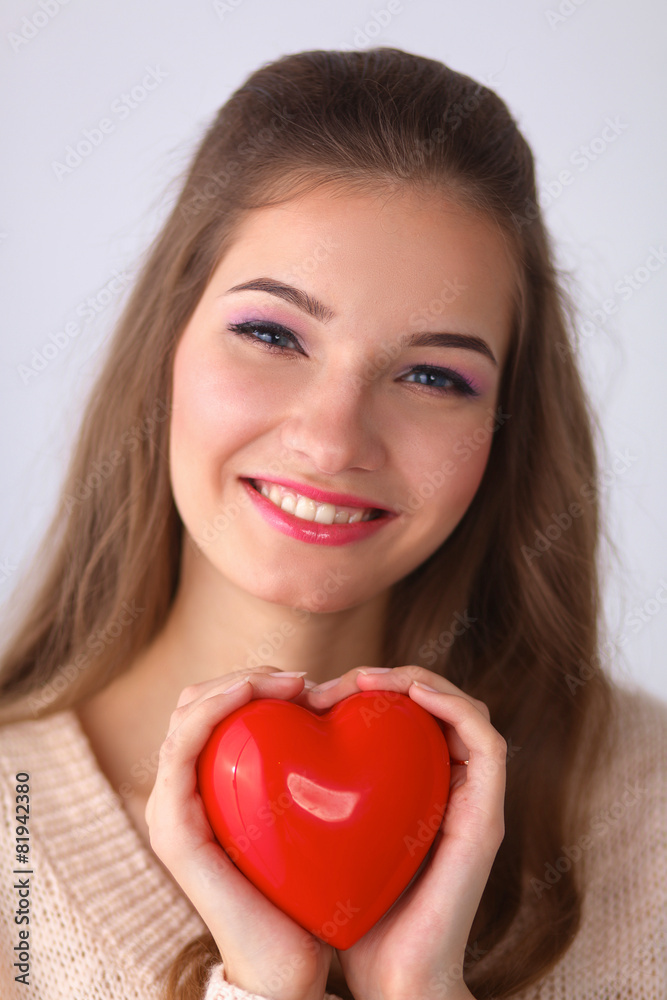 Portrait of beautiful happy woman holding a symbol heart. Portrait of beautiful happy woman holding a symbol heart.