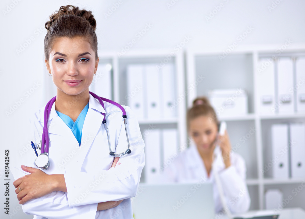 Portrait of young woman doctor with white coat standing in Portrait of young woman doctor with white coat standing in