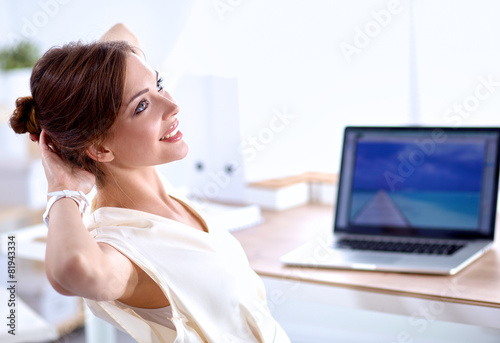 Business woman  relaxing with  hands behind her head and sitting