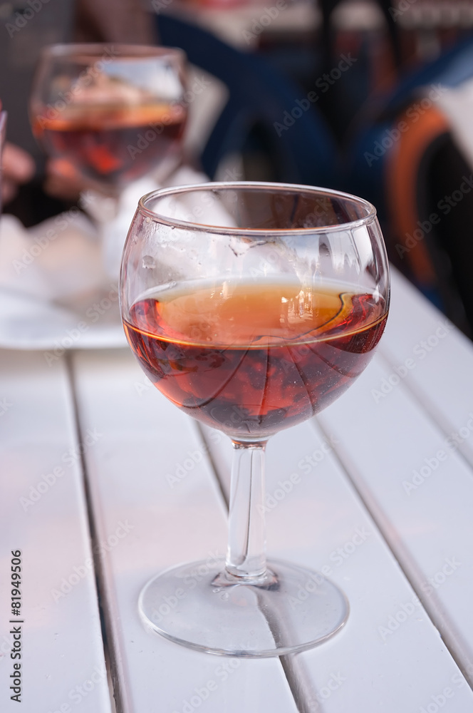 Glass of wine on the white table.Sweet dessert Italian red wine.
