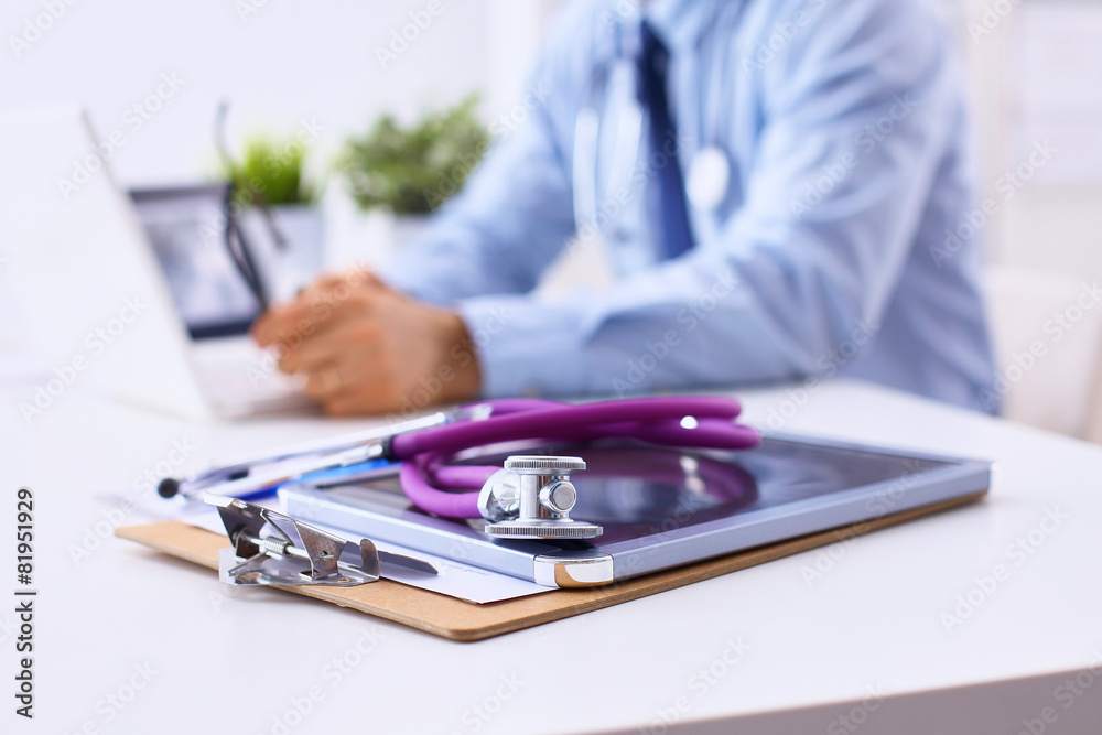 Fototapeta premium Male doctor sitting at his desk