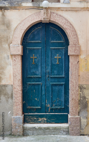 Stone portal and a wooden door to the church. © GKor