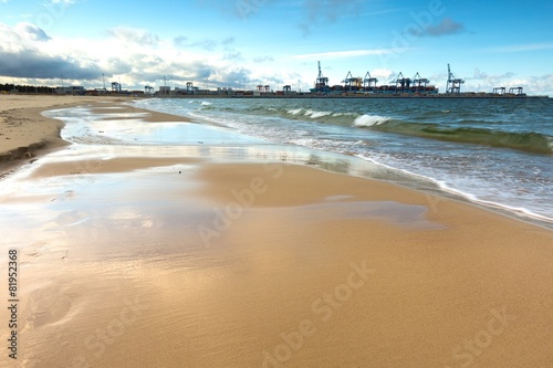Fototapeta Naklejka Na Ścianę i Meble -  Beautiful sandy sea shore with port