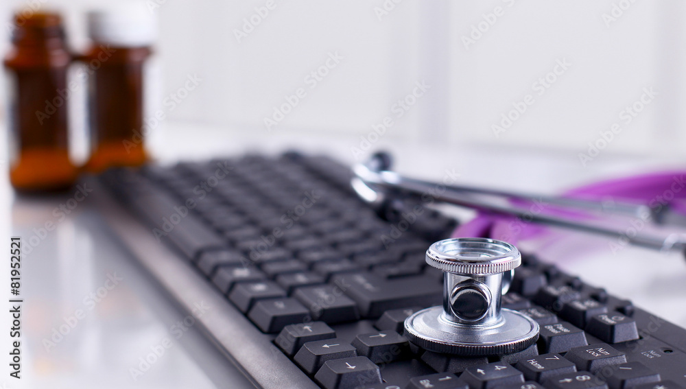 Violet stethoscope on a laptop computer Violet stethoscope on a laptop computer