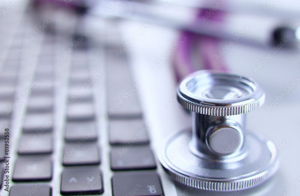Violet stethoscope on a laptop computer Violet stethoscope on a laptop computer