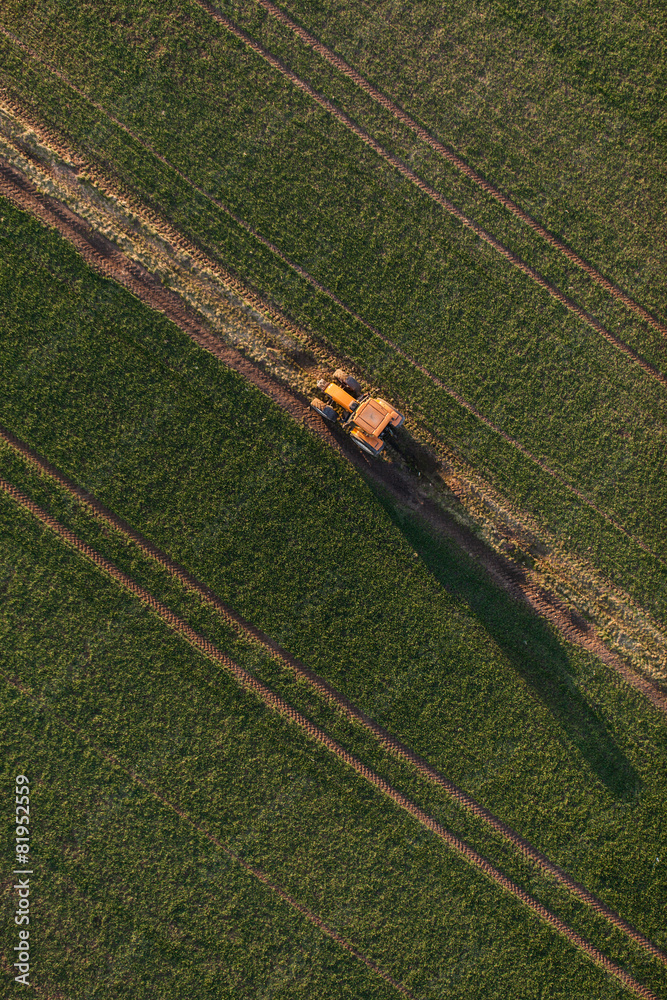 Obraz premium aerial view of harvest fields with tractor