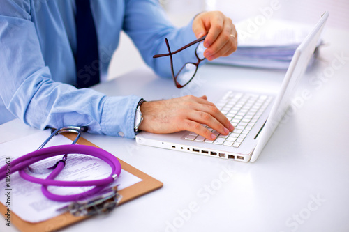 Doctor working at his desk with stethoscope