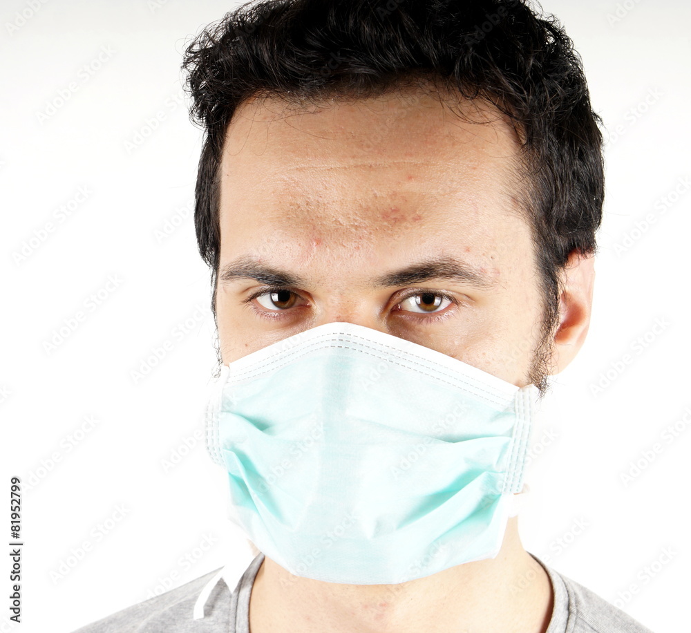 Studio shot of a young man with surgical mask Studio shot of a young man with surgical mask