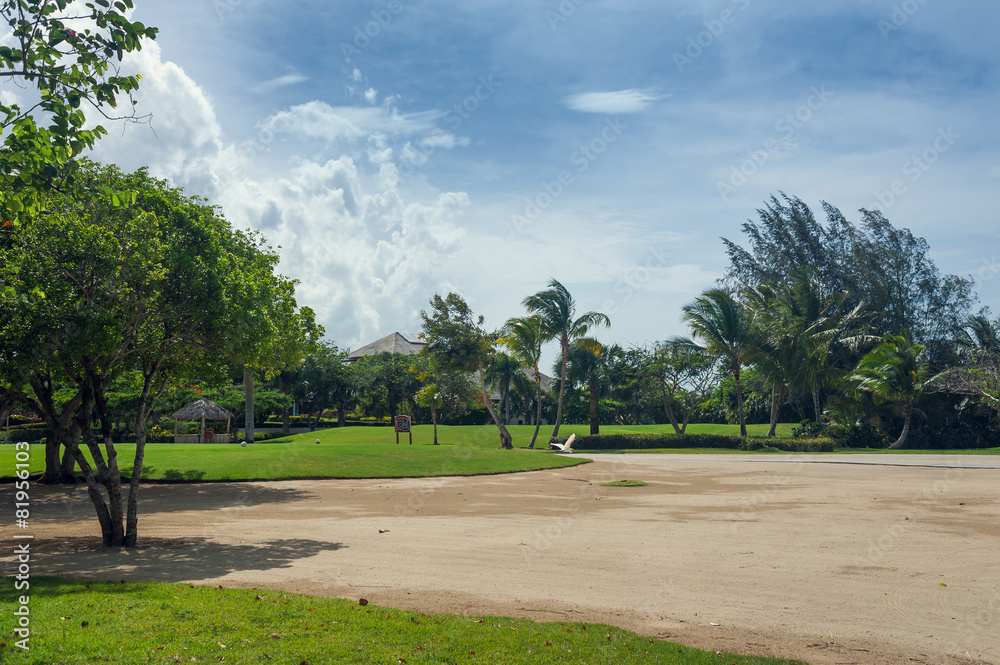 Golf course in Dominican republic. field of grass and coconut Golf course in Dominican republic. field of grass and coconut