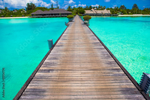 Beautiful tropical view of perfect ideal island, wooden jetty © travnikovstudio