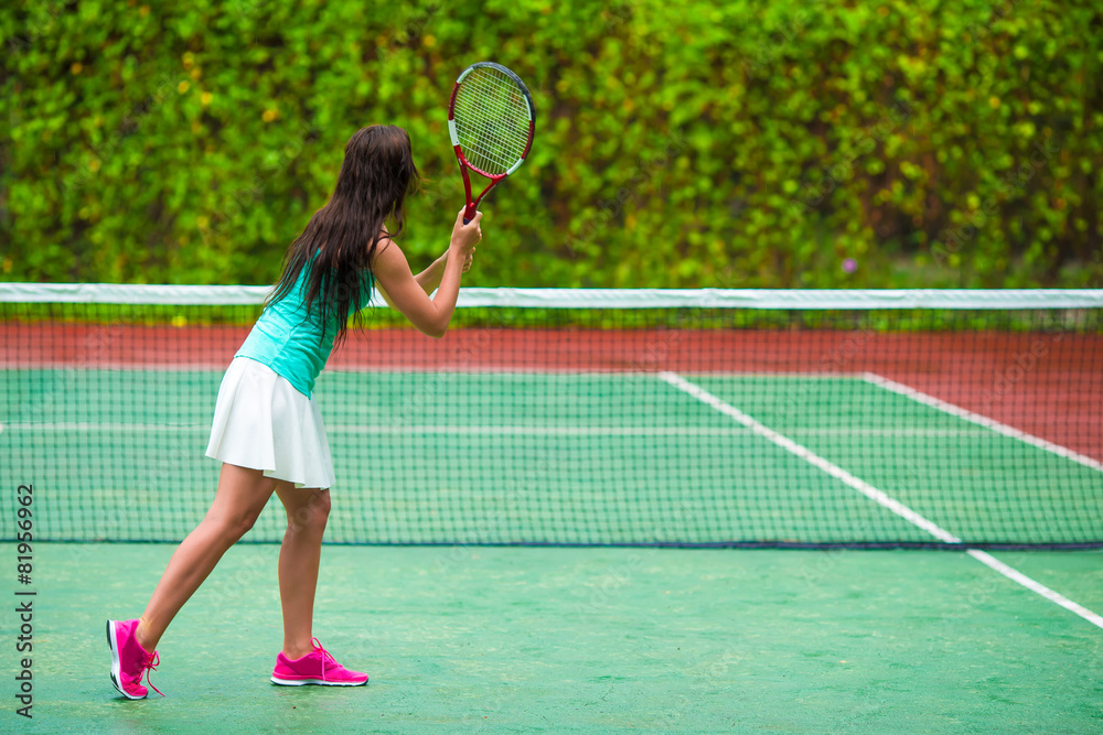 Young sportswoman playing tennis on tropical vacation