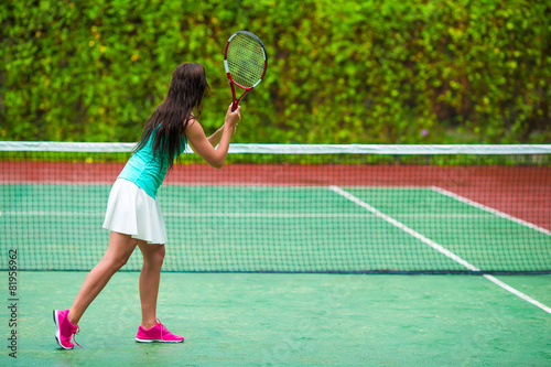 Young sportswoman playing tennis on tropical vacation © travnikovstudio