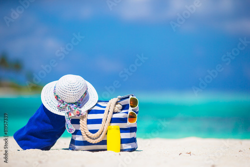 Blue stripe bag and towel, straw white hat, sunglasses