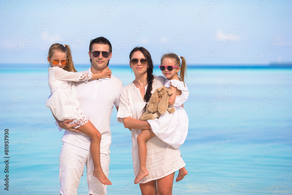 Young family of four on beach vacation Young family of four on beach vacation
