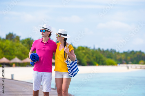 Couple on beach jetty at tropical island