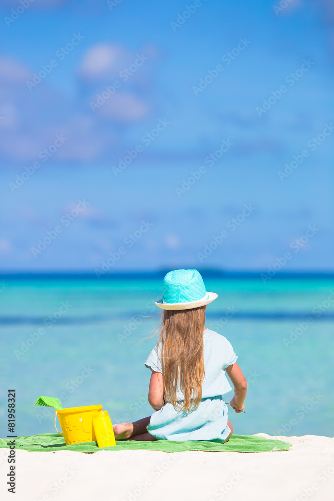 Cute little girl in hat at beach during summer vacation Cute little girl in hat at beach during summer vacation