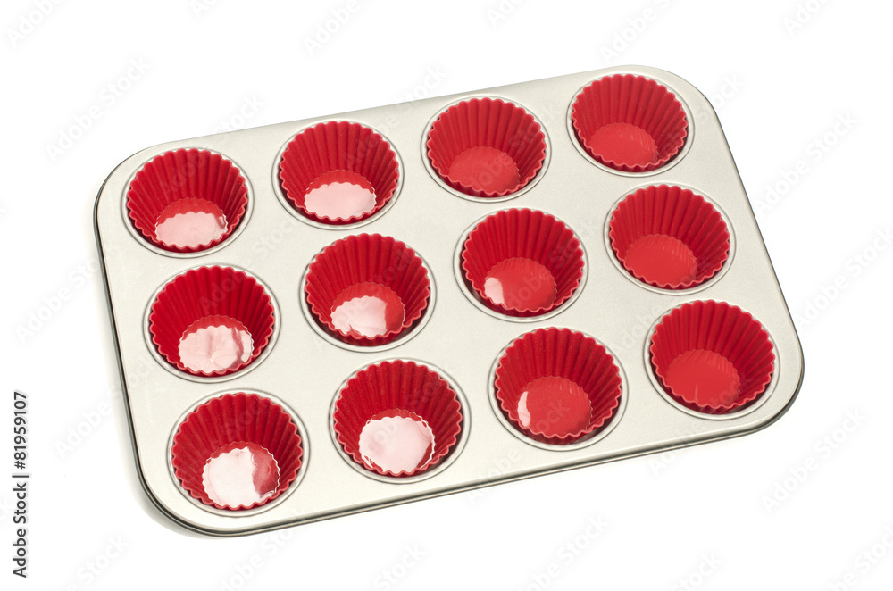 Cupcake tray with red silicone liners.Muffin metal tray isolated Cupcake tray with red silicone liners.Muffin metal tray isolated