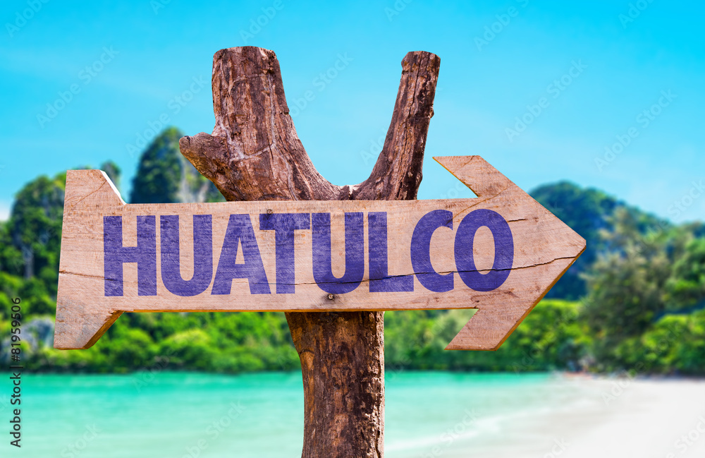 Huatulco wooden sign with beach background