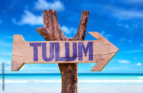 Tulum wooden sign with beach background