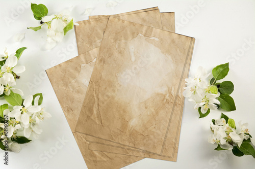 Old crumpled paper with white flowers white background photo