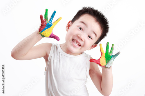 Chinese boy painting with hands with different color paint on his palms