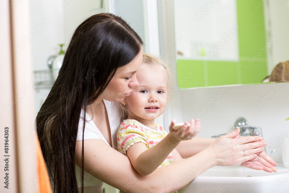 mother teaches kid washing hands in bathroom mother teaches kid washing hands in bathroom