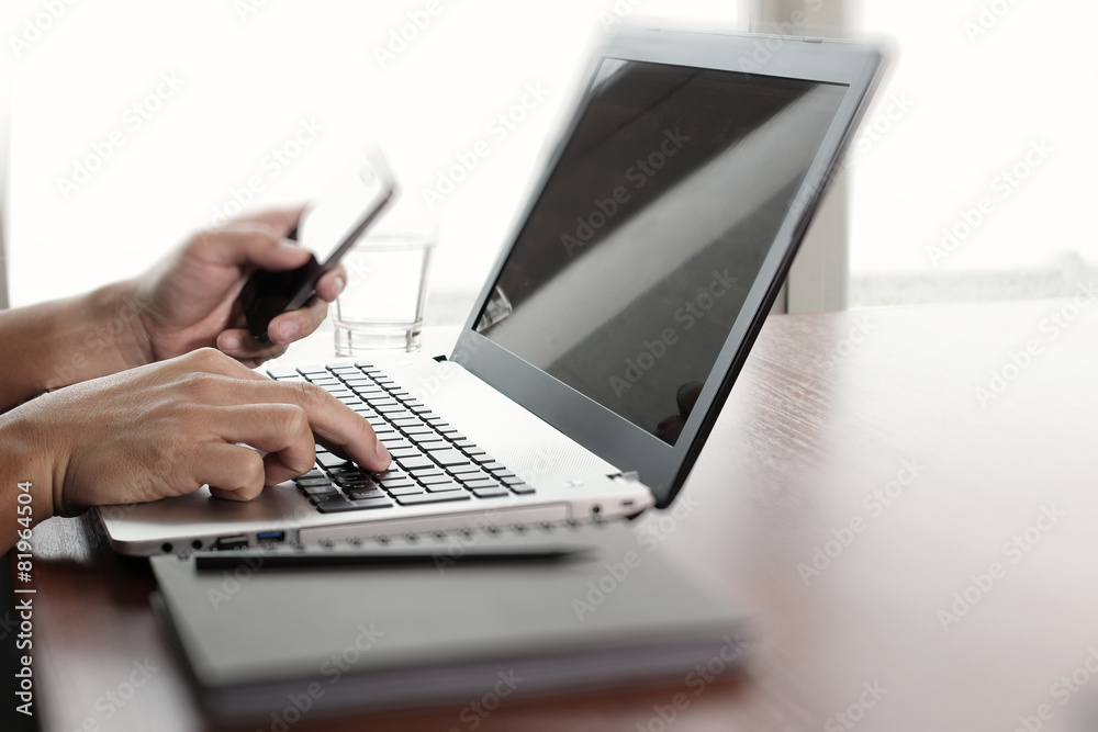 Close up of business man working on laptop computer on wooden de