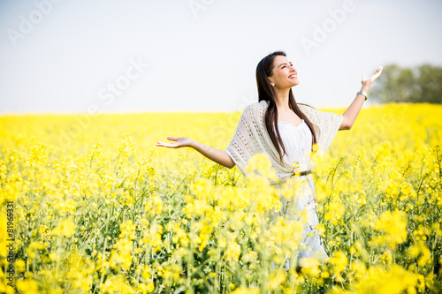 Young woman in the spring field