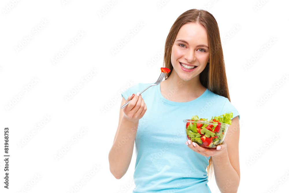 Portrait of a fit healthy woman eating a fresh salad isolated on Portrait of a fit healthy woman eating a fresh salad isolated on
