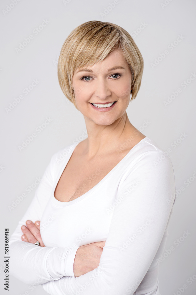 Confident woman posing over grey