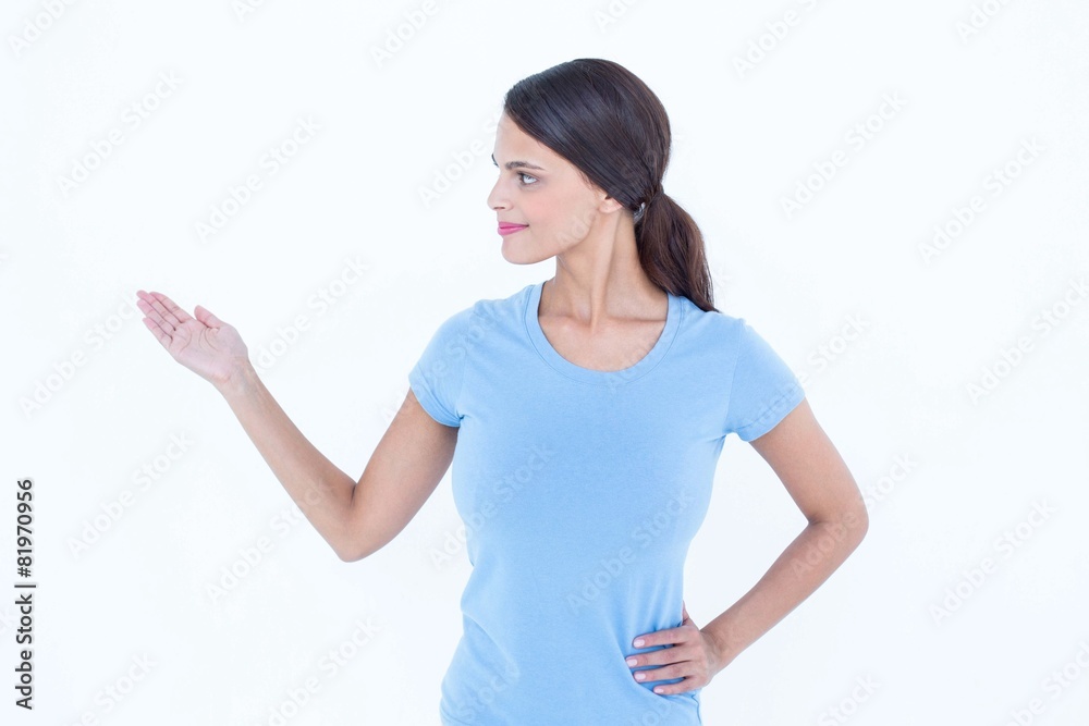 Woman smiling presenting something with her hand Woman smiling presenting something with her hand