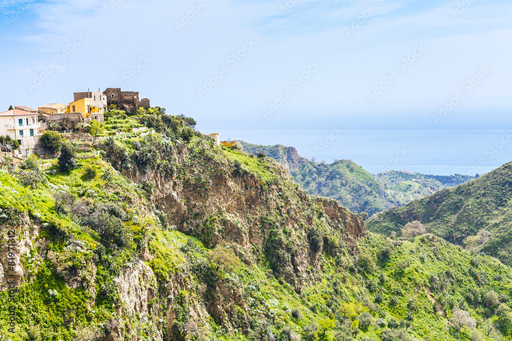 mountain town Savoca in Sicily and sea on horizon