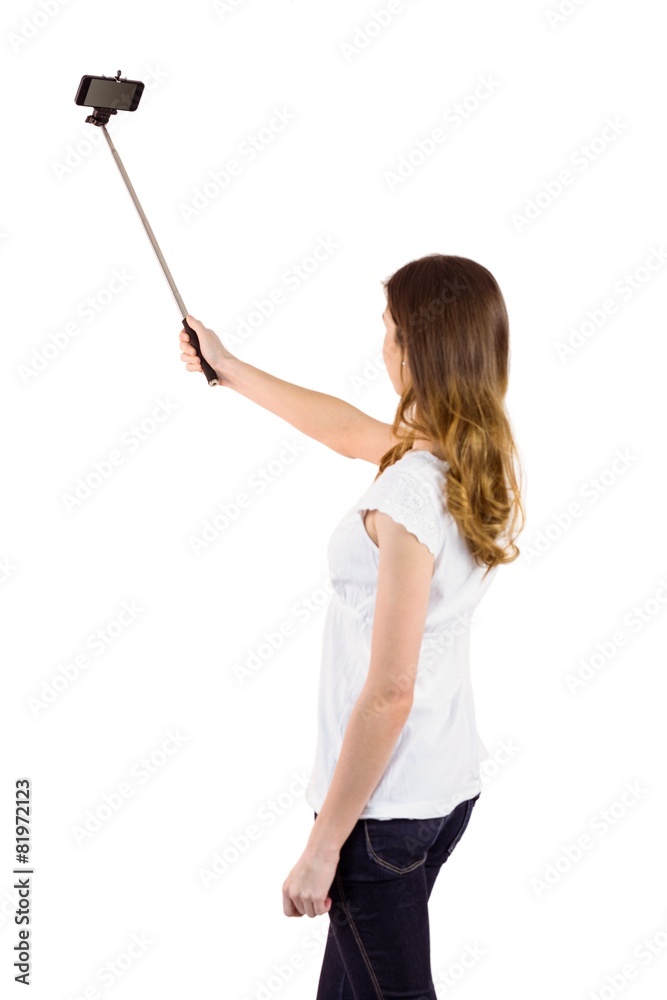 Pretty woman using a selfie stick Pretty woman using a selfie stick