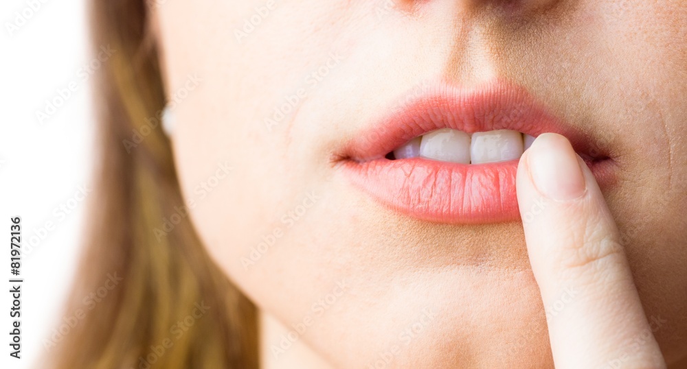 Fototapeta premium Woman pointing to her lips