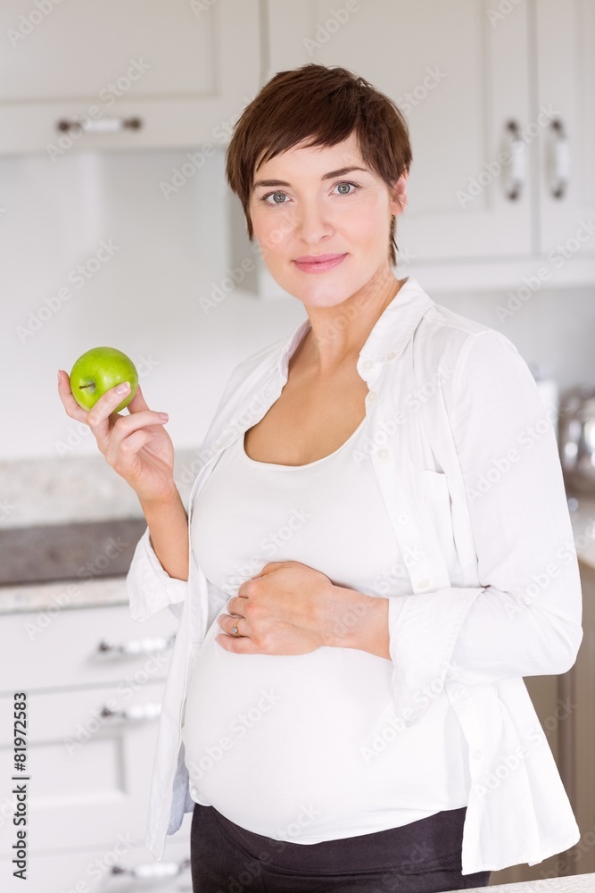 Pregnant woman eating an apple Pregnant woman eating an apple