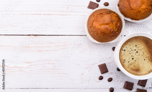 Coffee cup with a muffin . Background.