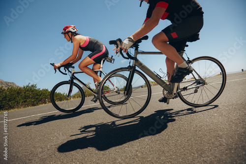 Fototapeta Naklejka Na Ścianę i Meble -  Cyclist riding bicycles down hill on country road