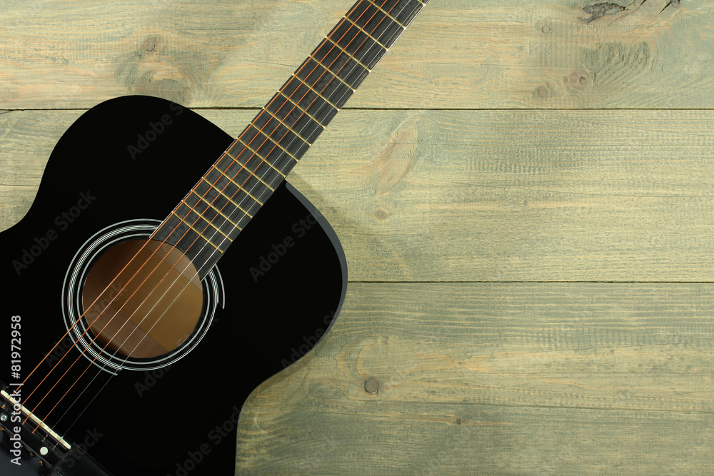 Fototapeta premium Acoustic guitar on wood background