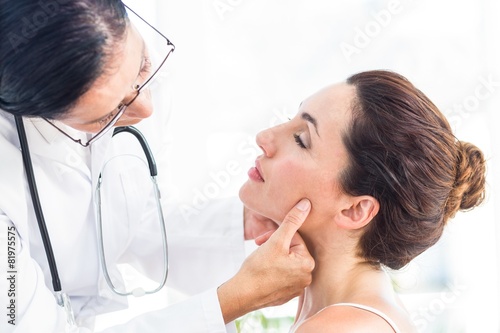 Doctor examining her patients jaw photo