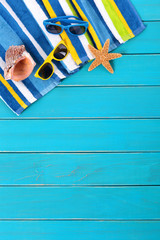Beach background border summer vacation holiday with accessories on old blue wood planked decking space for copy text photo vertical