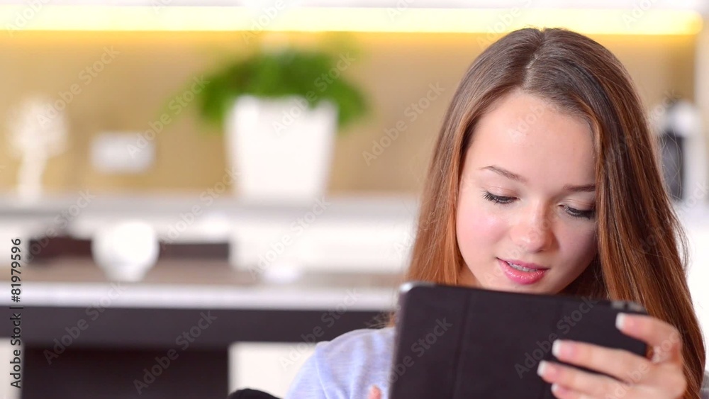 Beautiful Smiling Teenage Girl using Tablet PC Beautiful Smiling Teenage Girl using Tablet PC