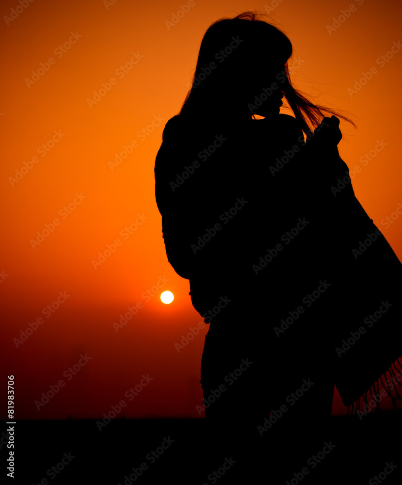 Silhouettes of people under the sunset