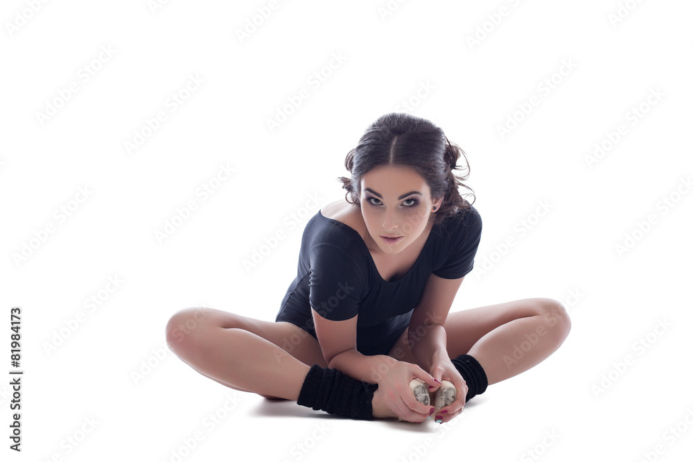 Fototapeta premium Lovely ballerina posing at camera while warming up