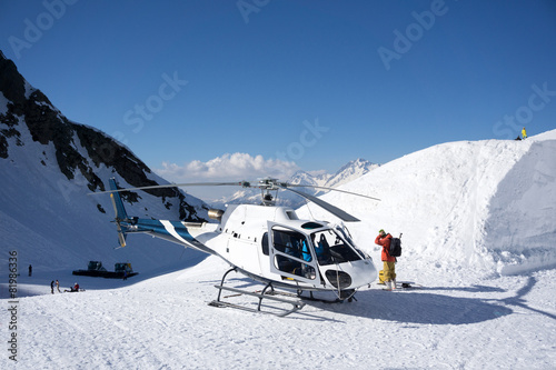 White rescue helicopter parked in the mountains